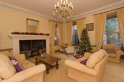 a living room with a christmas tree in it at Hockwold Hall - Former Royal residence in Hockwold cum Wilton