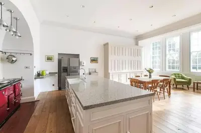 a kitchen and dining room with a counter and a table at Hockwold Hall - Former Royal residence in Hockwold cum Wilton