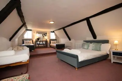 a living room with two beds and a couch at Hockwold Hall - Former Royal residence in Hockwold cum Wilton