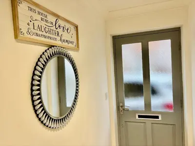 a mirror on a wall next to a door at Conveniently located 3 bed spacious home for couples, families and groups in Ipswich in Ipswich