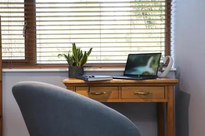 a desk with a laptop computer sitting on top of it at Oak View Lodge Luxury Master Studio near Ipswich & Woodbridge in Playford