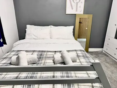 a bed with pillows on it in a bedroom at Double bedrooms In Spacious Home in Harold Wood