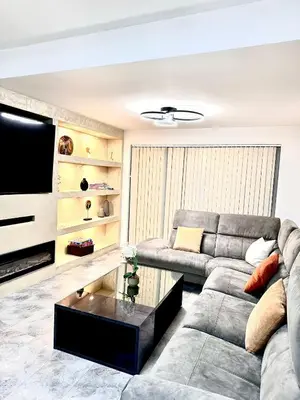 a living room with a couch and a coffee table at Double bedrooms In Spacious Home in Harold Wood