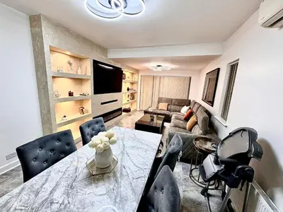 a living room with a table and a couch at Double bedrooms In Spacious Home in Harold Wood