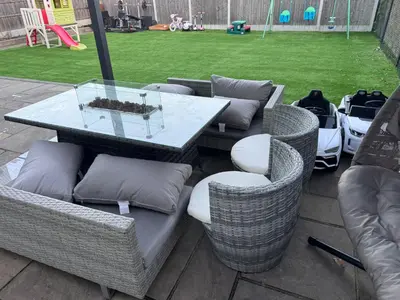 a patio with a table and chairs and a playground at Double bedrooms In Spacious Home in Harold Wood