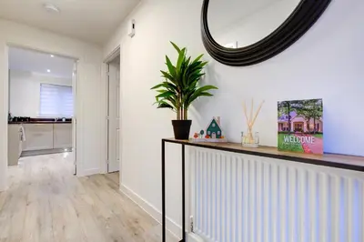 a living room with a mirror on the wall at Entire house in Stanway, Colchester in Colchester