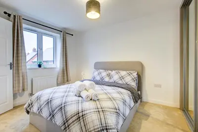 a bedroom with a bed with two teddy bears on it at Entire house in Stanway, Colchester in Colchester
