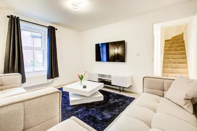 a living room with a couch and a tv at Entire house in Stanway, Colchester in Colchester