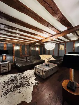 a living room with a couch and a table at The Foremans House, With Hot Tub, A luxurious Historical pre 16th Century Grade II Listed House, location Essex in a picturesque Village, Country Pub In walking Distance in Ridgewell