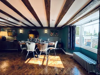 a dining room with green walls and a table and chairs at The Foremans House, With Hot Tub, A luxurious Historical pre 16th Century Grade II Listed House, location Essex in a picturesque Village, Country Pub In walking Distance in Ridgewell
