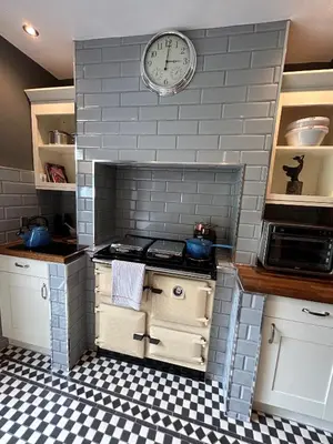 a small kitchen with a clock on the wall at The Foremans House, With Hot Tub, A luxurious Historical pre 16th Century Grade II Listed House, location Essex in a picturesque Village, Country Pub In walking Distance in Ridgewell
