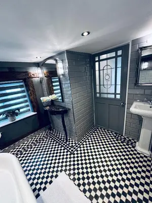 a bathroom with a black and white checkered floor at The Foremans House, With Hot Tub, A luxurious Historical pre 16th Century Grade II Listed House, location Essex in a picturesque Village, Country Pub In walking Distance in Ridgewell