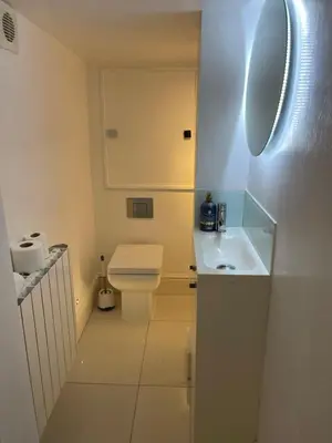 a white bathroom with a toilet and a sink at Elegant Victorian house - very best central location in historical city centre in Cambridge