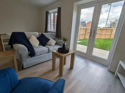a living room with a couch and a table at Newly Built Thetford Retreat in Watton