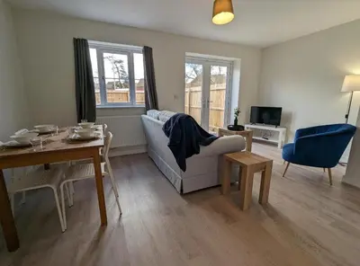 a living room with a couch and a table at Newly Built Thetford Retreat in Watton