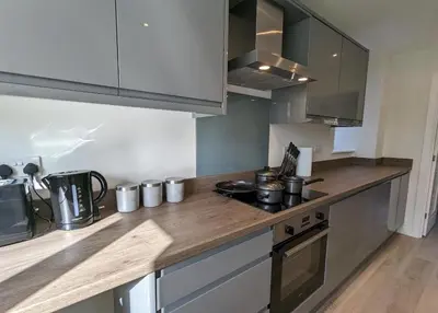 a kitchen with a wooden counter top with a stove at Newly Built Thetford Retreat in Watton