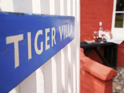 a blue sign that reads iceer will on a house at Tiger Villa by The Suffolk Cottage Collection in Aldeburgh