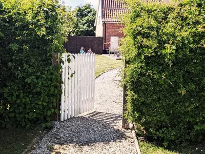 a white picket fence in front of a yard at The Cottage by The Suffolk Cottage Collection in Peasenhall