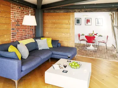 a living room with a couch and a table at The Seed Store by The Suffolk Cottage Collection in Peasenhall