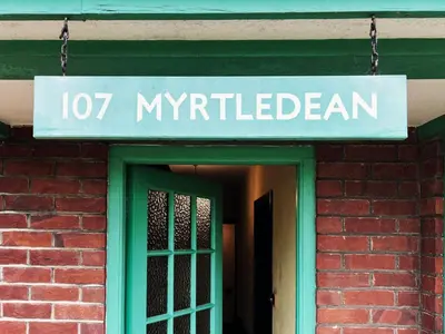 a sign that reads myrtleben on a brick building at The Vintage House by The Suffolk Cottage Collection in Aldeburgh