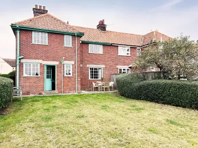 a large red brick house with a yard at The Vintage House by The Suffolk Cottage Collection in Aldeburgh