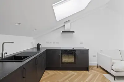 a kitchen with a black counter top and a sink at Navigation Yard in Chelmsford