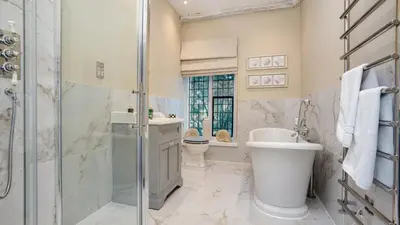 a bathroom with a shower and a sink and a toilet at Gatehouse East in Saint Osyth