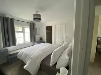 a bedroom with a large bed with white sheets and pillows at Paddock View - Snetterton Norfolk in Norwich