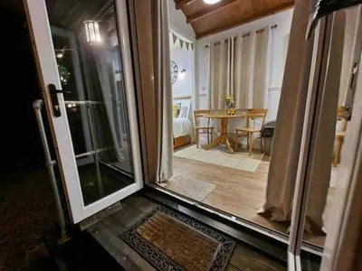 an open door to a living room with a table at Back in Thyme in Colchester