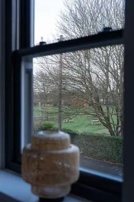 a window with a view of a green yard at Beautiful 2 Bedroom Home in Cambridge