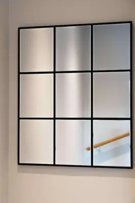 a frame of white squares on a wall at Beautiful 2 Bedroom Home in Cambridge