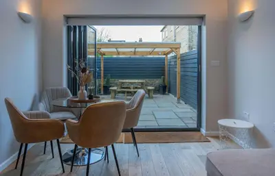a living room with a table and chairs at Beautiful 2 Bedroom Home in Cambridge