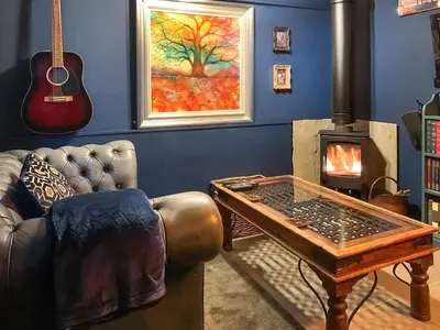 a living room with a couch and a wood stove at The Fox - Uk48554 in Colchester