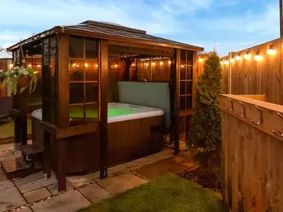 a bath tub in a wooden house in a yard at The Fox - Uk48554 in Colchester