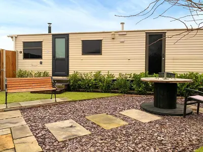 a house with a bench and a table in a yard at The Fox - Uk48554 in Colchester