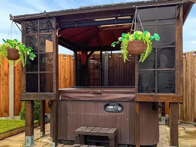 a wooden out house with two baskets and a bench at The Fox - Uk48554 in Colchester