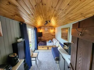 a room with a kitchen and a room with a bedroom at M Lodge in Colchester