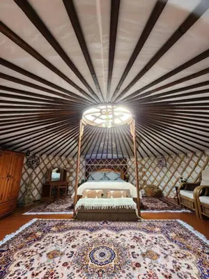 a bedroom with a bed in a yurt at The Roundhouse Yurt in Colchester