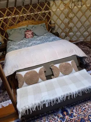 a bedroom with a bed with teddy bears on it at The Roundhouse Yurt in Colchester
