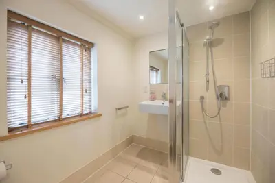a bathroom with a shower and a sink at Kiln House, Snape Maltings in Snape