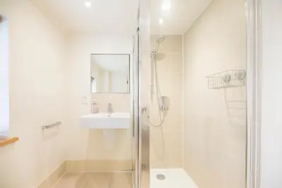 a bathroom with a shower and a sink at Kiln House, Snape Maltings in Snape