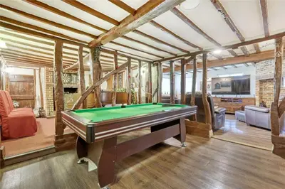 a living room with a pool table in it at Blackbrook Farmhouse with free off-street parking for 10 cars in Colchester