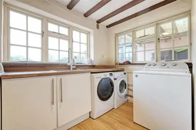 a laundry room with a washer and dryer at Blackbrook Farmhouse with free off-street parking for 10 cars in Colchester