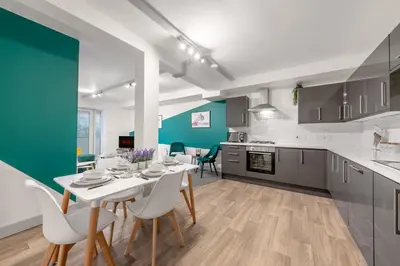 a kitchen and dining room with a table and chairs at The Jockey Suite-Newmarket High Street-Two Double Bedroom Apartment in Newmarket