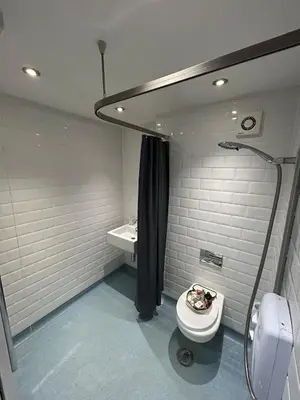 a bathroom with a shower and a toilet and a sink at HERTFORD House with garden parking pet friendly pool room in Hertford