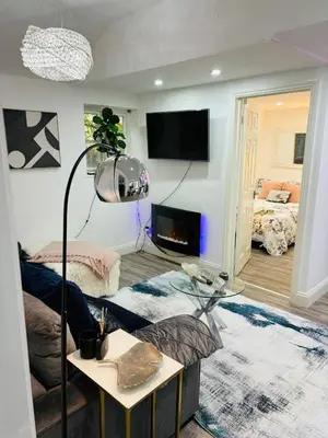 a living room with a couch and a table at HERTFORD House with garden parking pet friendly pool room in Hertford