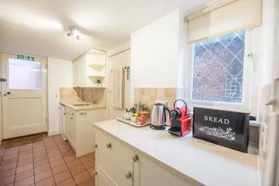 a kitchen with a counter with a coffee maker on it at Ann Page Cottage, Aldeburgh in Aldeburgh