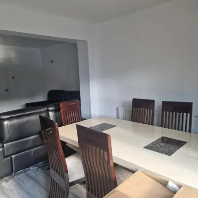 a dining room with a table and chairs at Cosy large double room in Basildon