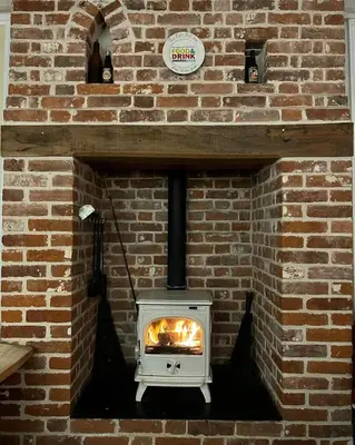 a brick oven with a fire in it at The Eelsfoot inn in Theberton