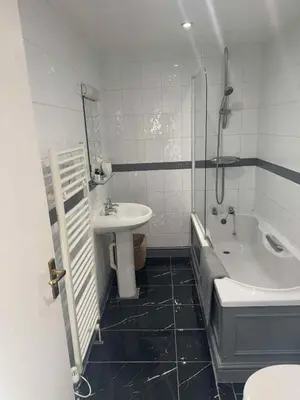 a bathroom with a sink and a tub and a toilet at The Eelsfoot inn in Theberton